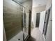 Modern shower with a glass door and decorative tile accents, enhancing the bathroom's aesthetic at 12253 S Bracco St, Winter Garden, FL 34787