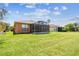 Expansive backyard with a well-maintained lawn and a screened lanai at 130 Los Gatos Pl, Kissimmee, FL 34759