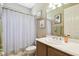 Well-lit bathroom with a shower-tub combo, decorated with beach-themed wall art at 130 Los Gatos Pl, Kissimmee, FL 34759