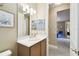 Bathroom featuring vanity with wood cabinets, neutral wall color, and views to the hallway at 130 Los Gatos Pl, Kissimmee, FL 34759