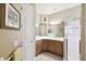 Bathroom featuring a corner vanity with white countertop and shower, all enhanced by natural light at 130 Los Gatos Pl, Kissimmee, FL 34759