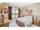 Bedroom with a large window overlooking a lush lawn, creating a serene and peaceful atmosphere at 130 Los Gatos Pl, Kissimmee, FL 34759