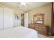 Bedroom featuring a large dresser with mirror and view into another living area, all enhanced by a ceiling fan at 130 Los Gatos Pl, Kissimmee, FL 34759