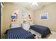 Nautical-themed bedroom with two twin beds, ceiling fan, and decorative wall art at 130 Los Gatos Pl, Kissimmee, FL 34759