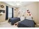 Nautical-themed bedroom with two twin beds, ceiling fan, and decorative wall art at 130 Los Gatos Pl, Kissimmee, FL 34759