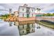 Scenic view of a building on the water with a stone bridge and reflective facade at 130 Los Gatos Pl, Kissimmee, FL 34759