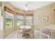 Cozy dining area with tile floors, lots of windows, and a ceiling fan at 130 Los Gatos Pl, Kissimmee, FL 34759