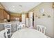 Bright dining area adjacent to kitchen, with tile flooring and comfortable seating at 130 Los Gatos Pl, Kissimmee, FL 34759