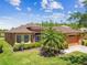 Charming single-story home featuring a well-manicured lawn and a neatly paved driveway leading to an attached two-car garage at 130 Los Gatos Pl, Kissimmee, FL 34759