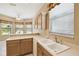 Kitchen with white countertops, cabinets, and a sink under a window at 130 Los Gatos Pl, Kissimmee, FL 34759