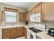 Well-lit kitchen with ample counter space, wood cabinets, and modern appliances at 130 Los Gatos Pl, Kissimmee, FL 34759