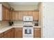 Bright kitchen features wood cabinets, white countertops, and modern white appliances at 130 Los Gatos Pl, Kissimmee, FL 34759