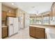 Bright and inviting kitchen featuring modern appliances, wood cabinets, and a tile floor at 130 Los Gatos Pl, Kissimmee, FL 34759