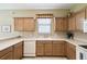 Spacious kitchen with updated appliances, wood cabinetry, and a bright, airy atmosphere at 130 Los Gatos Pl, Kissimmee, FL 34759