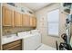 Laundry room featuring a washer, dryer, built-in cabinets, and a utility sink at 130 Los Gatos Pl, Kissimmee, FL 34759