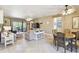 Open-concept living and dining area with tile floors, ceiling fans, and sliding glass doors to the patio at 130 Los Gatos Pl, Kissimmee, FL 34759