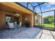 Rear patio with an outdoor kitchen, a ceiling fan, and a screened-in enclosure at 130 Los Gatos Pl, Kissimmee, FL 34759