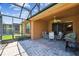 Spacious screened-in lanai with a table and grill, perfect for entertaining at 130 Los Gatos Pl, Kissimmee, FL 34759