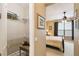 Walk-in closet featuring metal shelving adjacent to a bedroom with a comfortable bed and ceiling fan at 130 Los Gatos Pl, Kissimmee, FL 34759