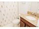 Bright bathroom featuring a granite countertop, floral shower curtain, and modern fixtures at 1302 Moss Creek Ln, Davenport, FL 33896