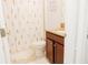 Bathroom with flower curtain, vanity with granite countertops, and toilet at 1302 Moss Creek Ln, Davenport, FL 33896