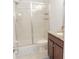 Bathroom featuring a glass shower, tile surround, single sink vanity, and tile flooring at 1302 Moss Creek Ln, Davenport, FL 33896