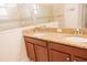 Bathroom features a double vanity with granite countertops and tiled glass shower at 1302 Moss Creek Ln, Davenport, FL 33896