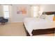 Spacious bedroom featuring a large bed, a comfortable chair, and lots of natural light at 1302 Moss Creek Ln, Davenport, FL 33896