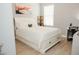 Bright bedroom with white furniture and plank flooring at 1302 Moss Creek Ln, Davenport, FL 33896