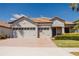 Charming single-story home with a paver driveway and a two-car garage and a blue sky backdrop at 1302 Moss Creek Ln, Davenport, FL 33896