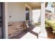 Welcoming front porch featuring stone accents, modern chairs, and a cozy seating area at 1302 Moss Creek Ln, Davenport, FL 33896