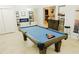 Game room with a beautiful pool table, custom bar area, and fireplace for luxurious entertaining at 1302 Moss Creek Ln, Davenport, FL 33896