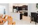 Modern kitchen featuring dark cabinetry, stainless steel appliances, and an open design at 1302 Moss Creek Ln, Davenport, FL 33896