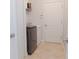 Laundry room with newer washer and dryer, tiled floor, and storage shelf at 1302 Moss Creek Ln, Davenport, FL 33896