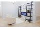 Bright living area with tile floors, white walls, decorative shelving, and modern electric fireplace at 1302 Moss Creek Ln, Davenport, FL 33896