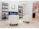 Bright living area with tile floors, white walls, decorative shelving, and modern electric fireplace at 1302 Moss Creek Ln, Davenport, FL 33896