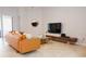 Bright living room with modern furniture, large-screen TV, and access to outdoor patio at 1302 Moss Creek Ln, Davenport, FL 33896
