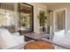 Relaxing screened patio boasts stylish furniture, a heater, and a glimpse of the surrounding backyard at 1302 Moss Creek Ln, Davenport, FL 33896