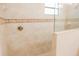 Shower features tiled walls with mosaic accents and glass surround at 1302 Moss Creek Ln, Davenport, FL 33896