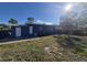 Backyard view of the blue home with a lawn at 139 Arroyo Pkwy, Ormond Beach, FL 32174