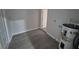 This is a basement with gray vinyl flooring, a water heater, and a doorway at 139 Arroyo Pkwy, Ormond Beach, FL 32174