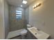 Tastefully remodeled bathroom with modern fixtures, a gray vanity, and a tiled shower area at 139 Arroyo Pkwy, Ormond Beach, FL 32174