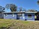 Charming, blue one story home with a simple front yard and crisp white trim details at 139 Arroyo Pkwy, Ormond Beach, FL 32174
