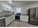 Bright kitchen features stainless steel appliances, sleek gray countertops, and modern fixtures at 139 Arroyo Pkwy, Ormond Beach, FL 32174