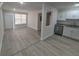 Sunlit open-concept living space connects seamlessly to kitchen with gray countertops and stainless appliances at 139 Arroyo Pkwy, Ormond Beach, FL 32174