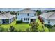 Aerial view showcasing the backyard, landscaping, and screened patio of the home at 1443 Bunker Dr, Davenport, FL 33836