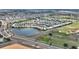 Scenic aerial view of a residential area with pond and golf course, offering picturesque views at 1443 Bunker Dr, Davenport, FL 33836