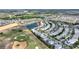 Overhead view of homes located alongside a scenic golf course and a beautiful pond at 1443 Bunker Dr, Davenport, FL 33836