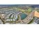 Aerial view of homes near a golf course and pond in a well-planned community at 1443 Bunker Dr, Davenport, FL 33836