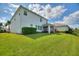 Spacious backyard with lush lawn, providing ample space and a screened-in porch at 1443 Bunker Dr, Davenport, FL 33836